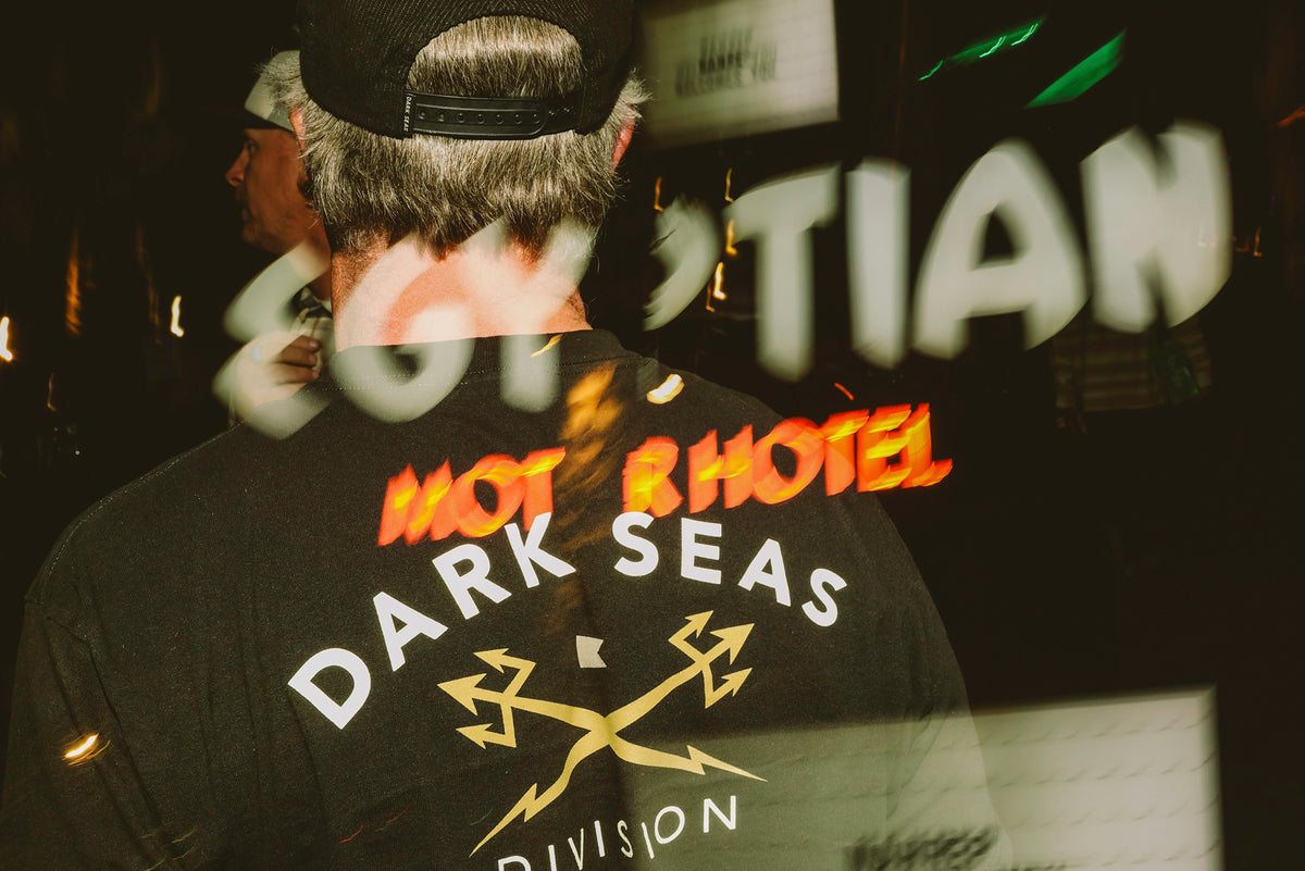 Photo of a man in a Dark Seas headmaster Tee shirt, dual images, with reflection of Egyptian Motel sign overlayed.