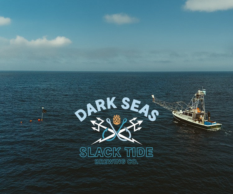 Aerial view of an ocean scene with a fishing boat on the right, a buoy on the left, and a large overlaid logo reading 'DARK SEAS SLACK TIDE BREWING CO.' in white and blue text with crossed scuba gear and a gold crown icon.